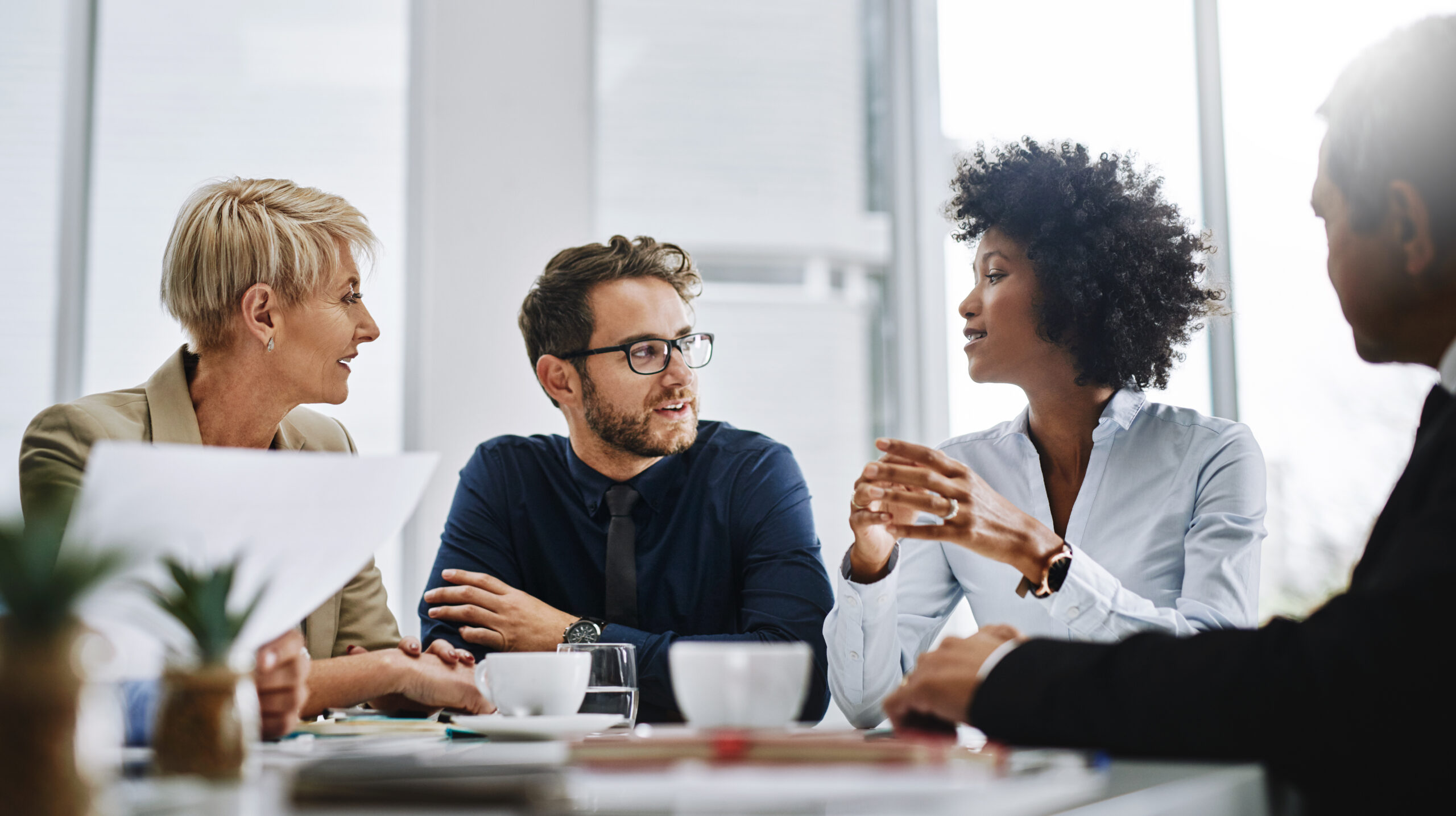 Background image of a businessman giving a speech during a coaching engagement